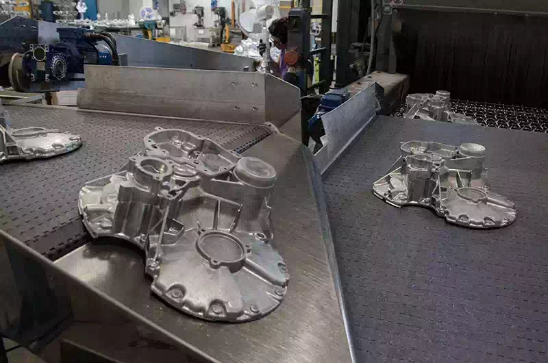 Granigliatura a tappeto con operaia che lavora sullo sfondo.